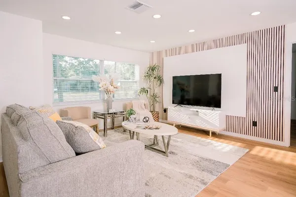 a living room with furniture and a flat screen tv