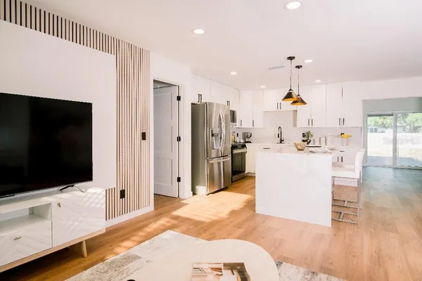 a view of living room with furniture and flat screen tv