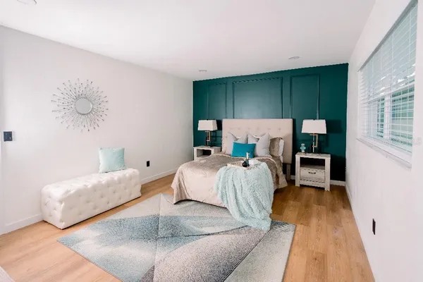 a bed room with a bed and a night stand