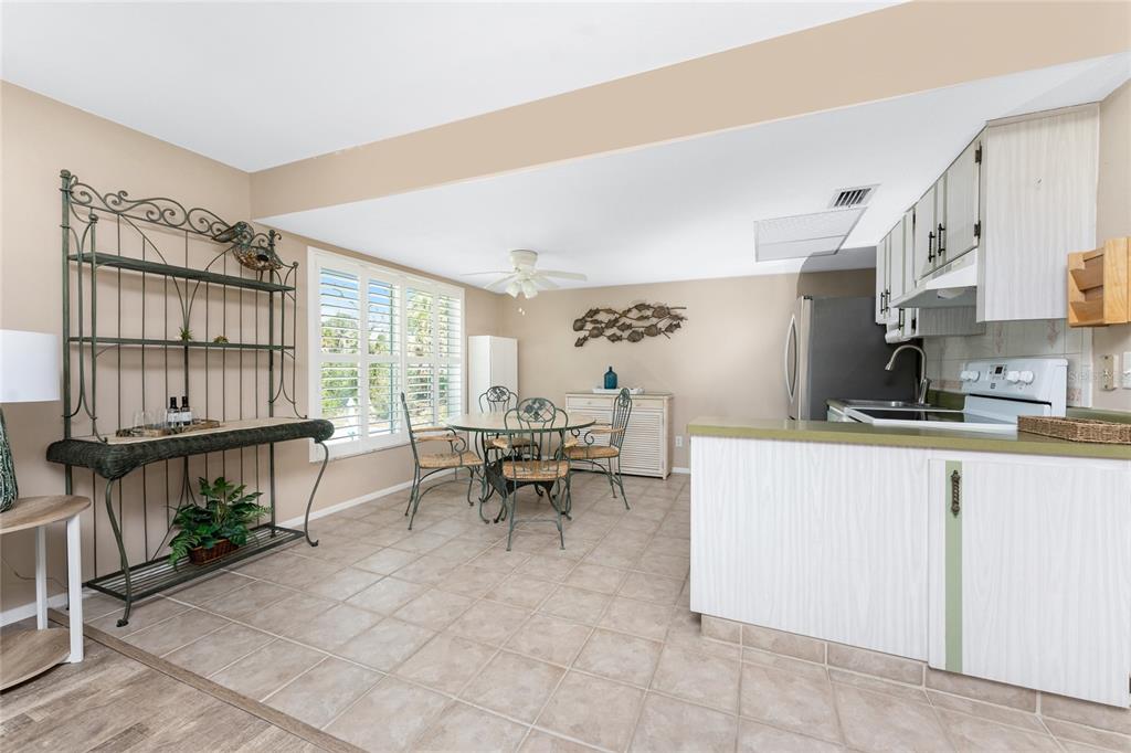 5055 North Beach Road, Unit 208 Englewood, FL 34223 - Photo 12 of 43 a living room with furniture a window and a table