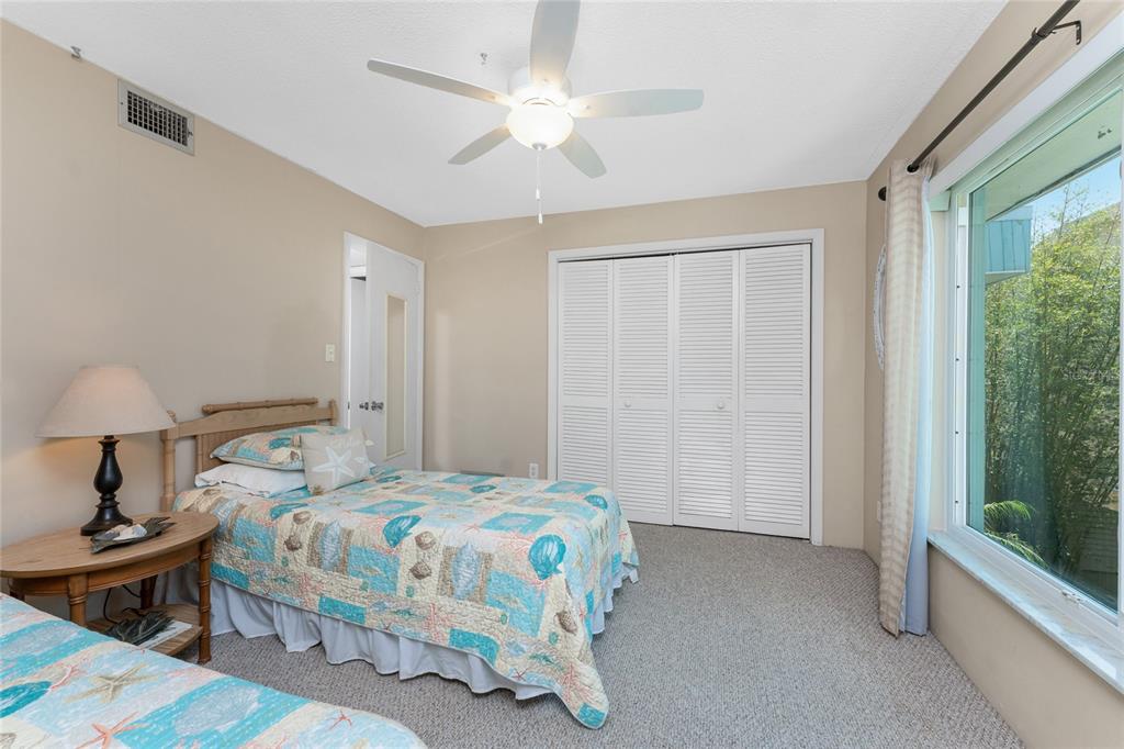 5055 North Beach Road, Unit 208 Englewood, FL 34223 - Photo 26 of 43 a bedroom with a bed and a chandelier