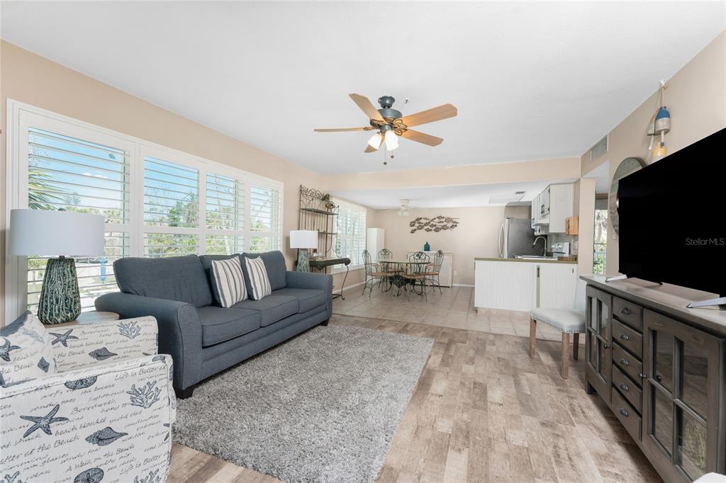 5055 North Beach Road, Unit 208 Englewood, FL 34223 - Photo 3 of 43 a living room with furniture and a flat screen tv