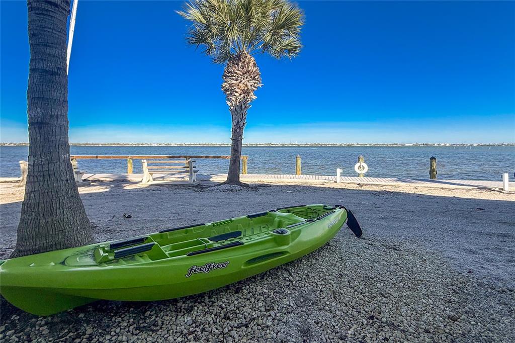 5055 North Beach Road, Unit 208 Englewood, FL 34223 - Photo 32 of 43 a view of a garden with a table and chairs