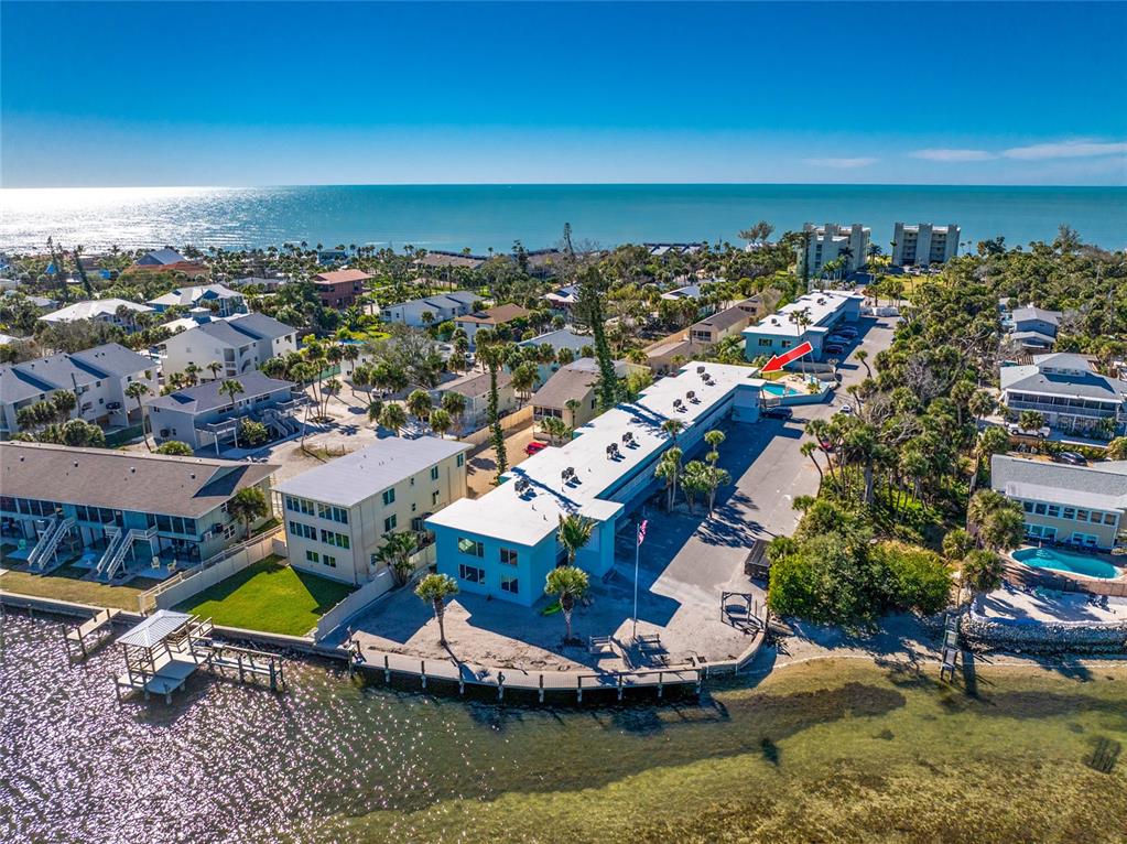 5055 North Beach Road, Unit 208 Englewood, FL 34223 - Photo 36 of 43 an aerial view of a house with a swimming pool outdoor seating and yard