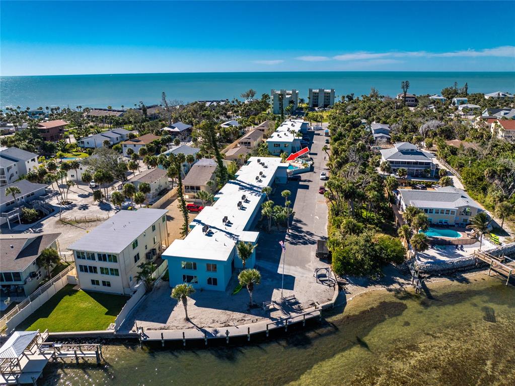 5055 North Beach Road, Unit 208 Englewood, FL 34223 - Photo 39 of 43 an aerial view of residential houses with yard and ocean view
