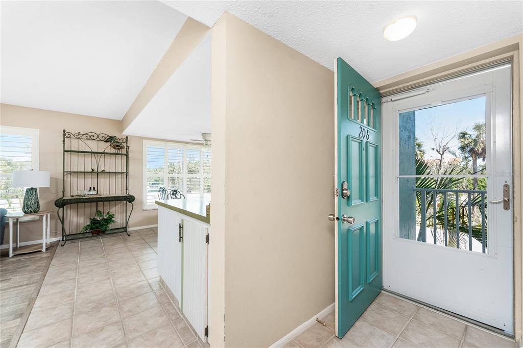 5055 North Beach Road, Unit 208 Englewood, FL 34223 - Photo 8 of 43 a view of a hallway with furniture and a window