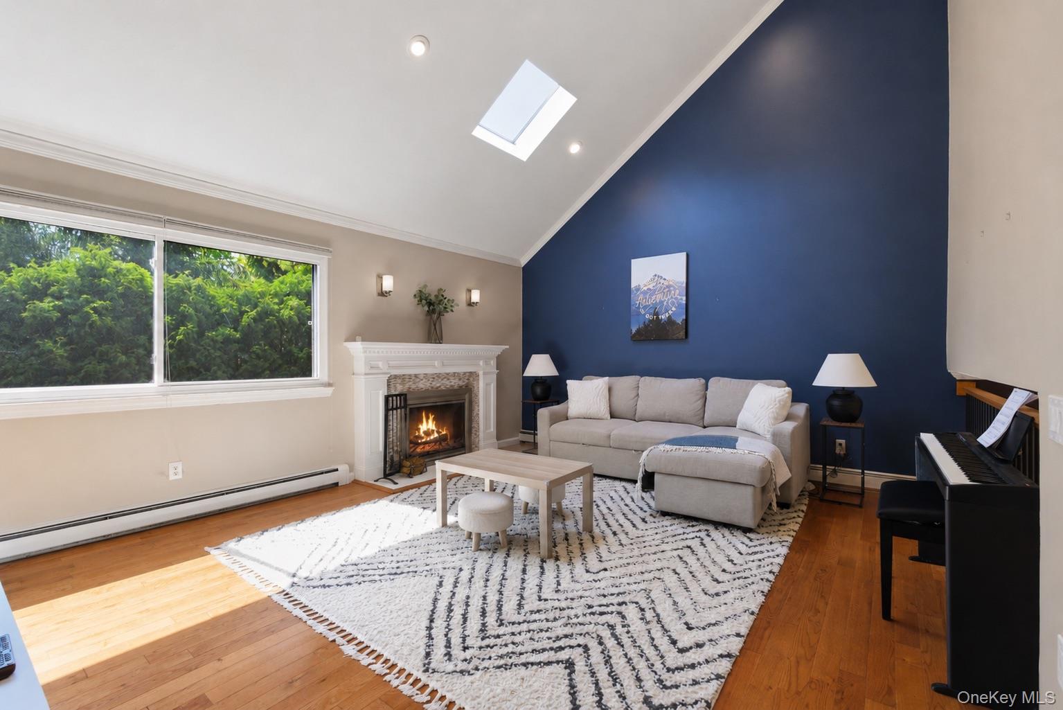 245 Tree Top Crescent Rye Brook, NY 10573 - Photo 6 of 24 a living room with furniture a fireplace and a floor to ceiling window