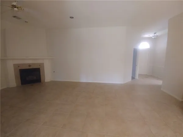 a view of empty room with a fireplace