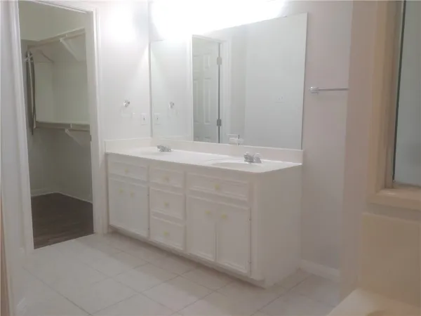 a bathroom with a double vanity sink and mirror