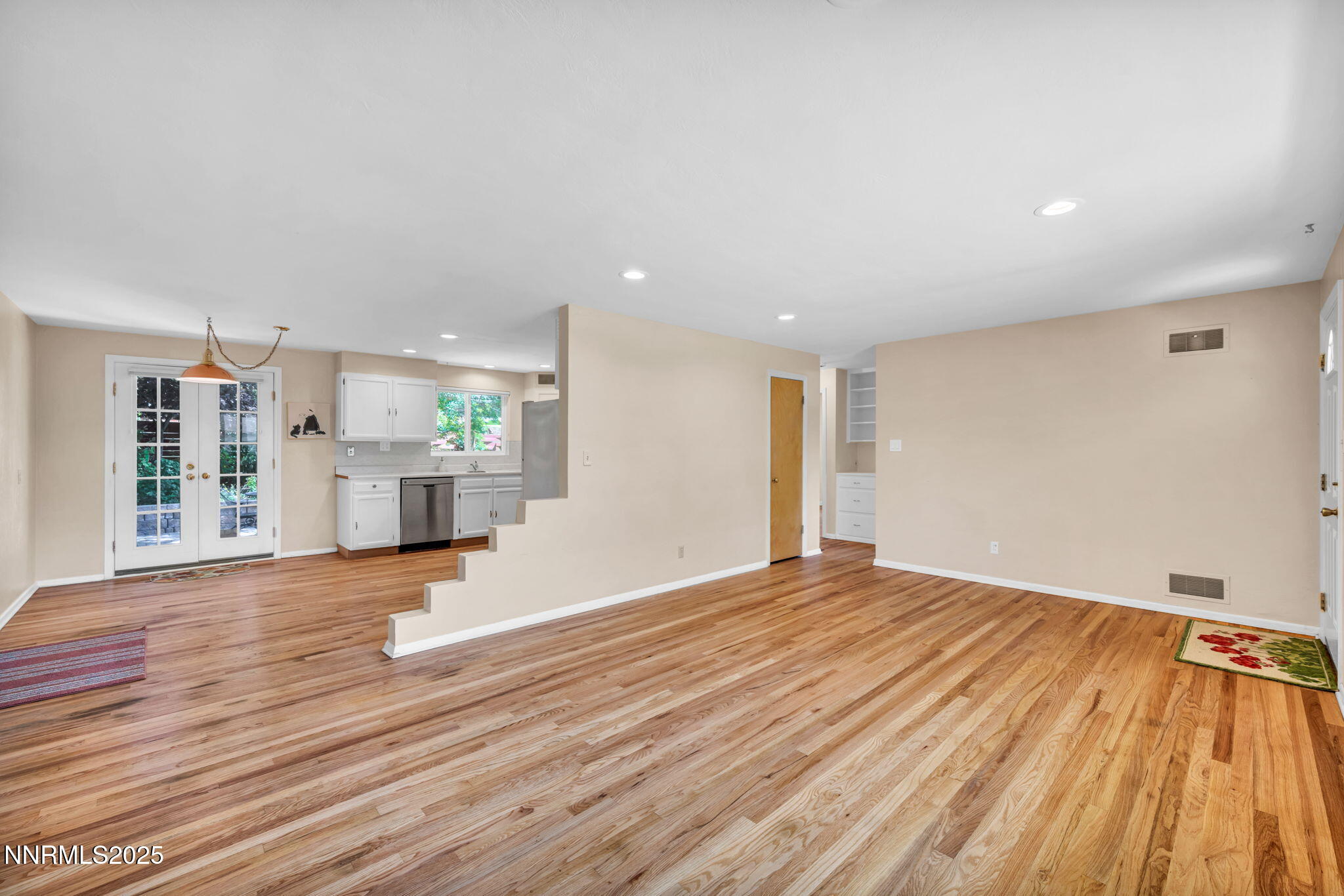 825 West 11th Street Reno, NV 89503 - Photo 2 of 26 a view of an empty room with wooden floor and a kitchen