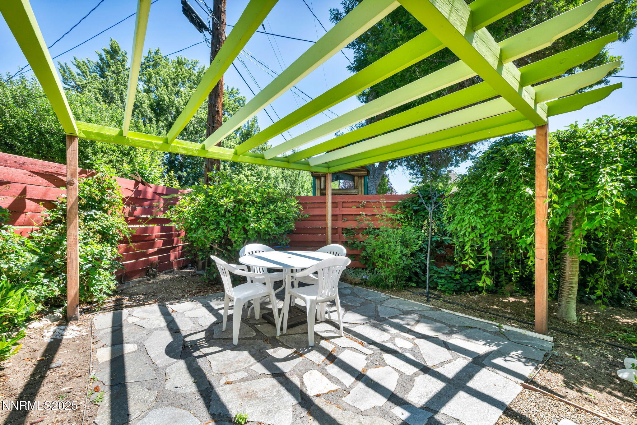 825 West 11th Street Reno, NV 89503 - Photo 23 of 26 a view of a patio with table and chairs potted plants with wooden floor and fence