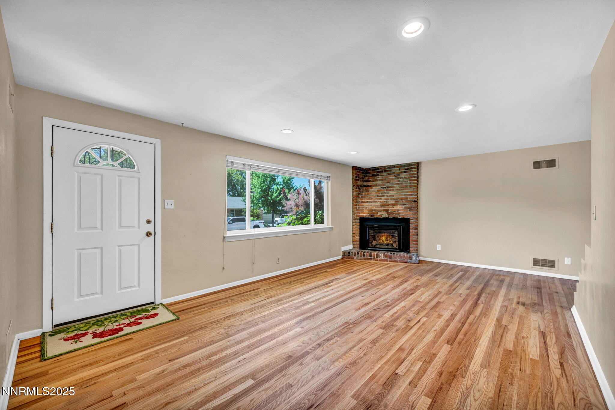 825 West 11th Street Reno, NV 89503 - Photo 4 of 26 a view of an empty room with wooden floor fireplace and a window