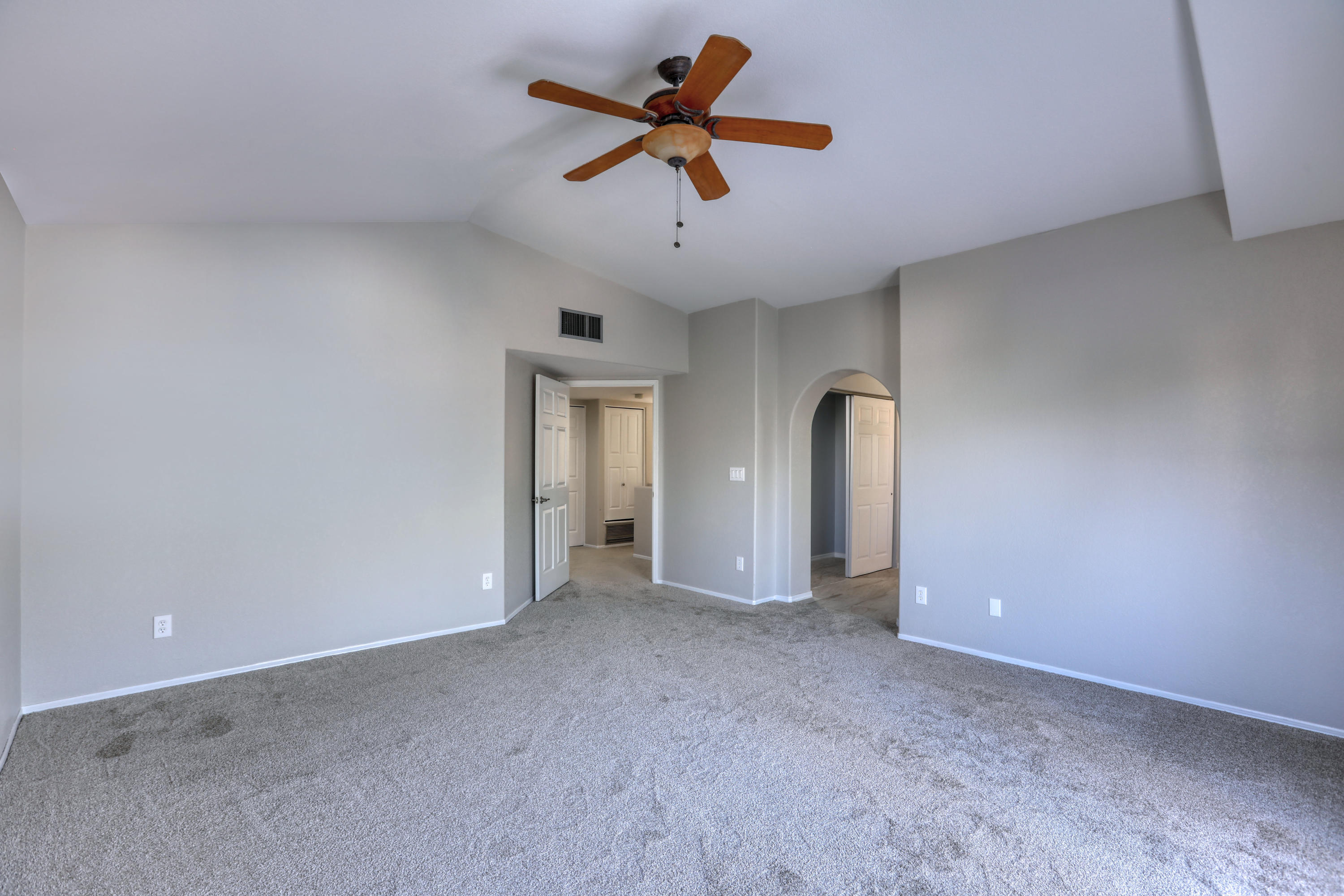 12560 North Wayfarer Way Oro Valley, AZ 85755 - Photo 26 of 43 an empty room with chandelier fan and windows