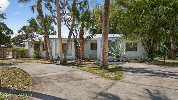 a view of a house with trees in the background