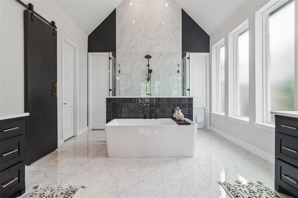 1920 Lotus Court Haslet, TX 76052 - Photo 16 of 40 Oversized soaking tub, dual shower doors to enter large walk in shower, 24x12 tile flow from the floor up the entire wall of the shower. 2 large walk in closets, linen closet.
