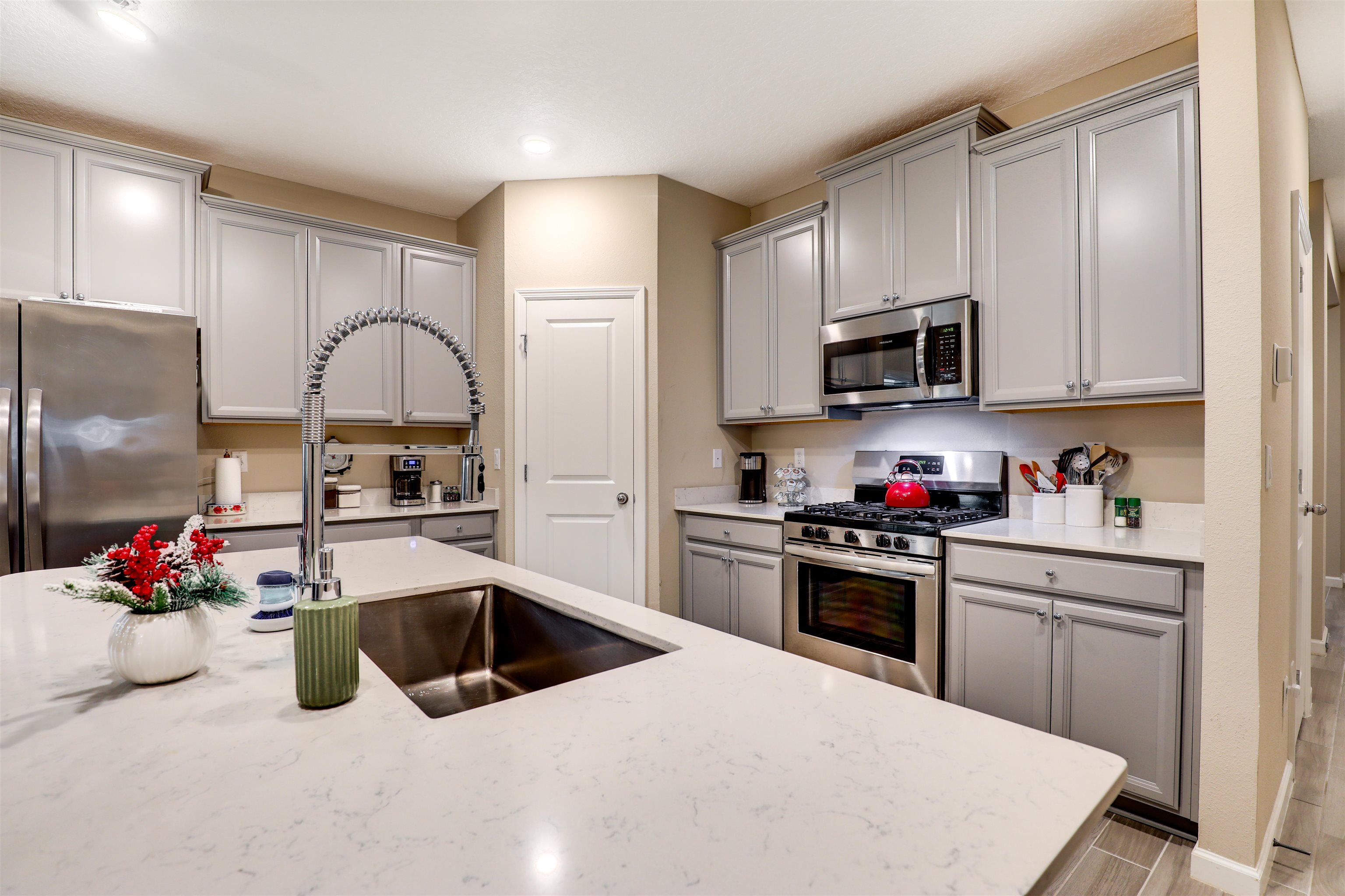 384 Gan Way St. Johns, FL 32259 - Photo 16 of 61 a kitchen with kitchen island a sink stainless steel appliances and cabinets