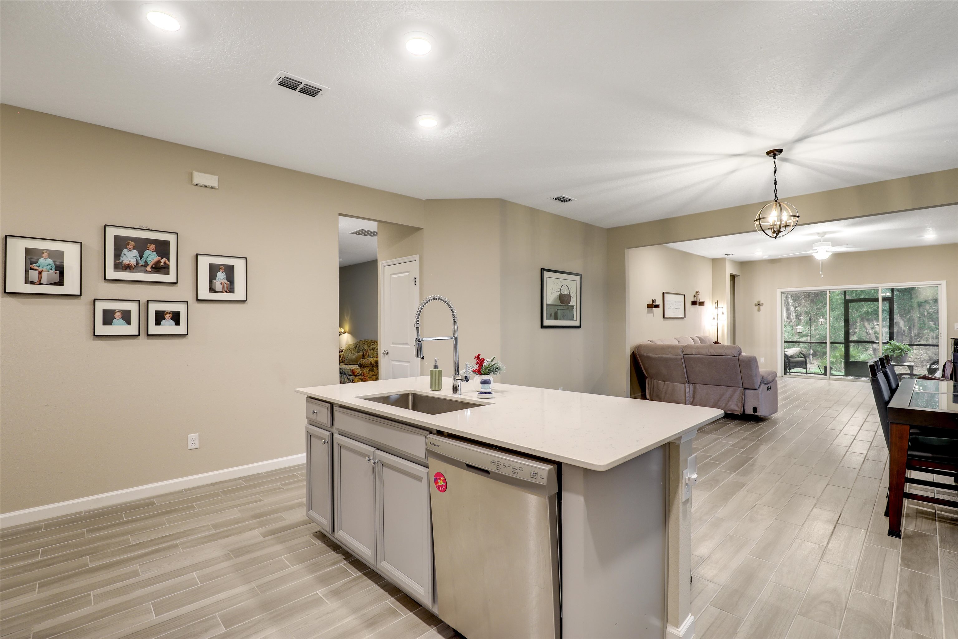 384 Gan Way St. Johns, FL 32259 - Photo 19 of 61 a living room with stainless steel appliances kitchen island a table chairs and a refrigerator