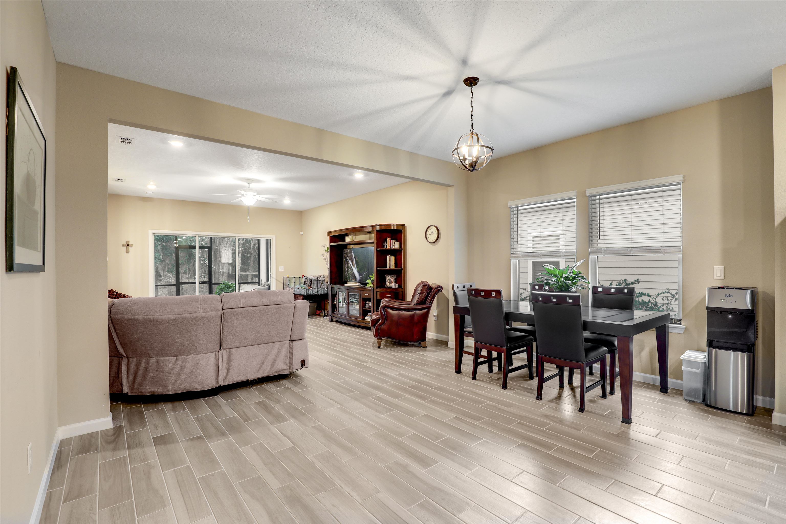 384 Gan Way St. Johns, FL 32259 - Photo 27 of 61 a living room with furniture dining table and a flat screen tv