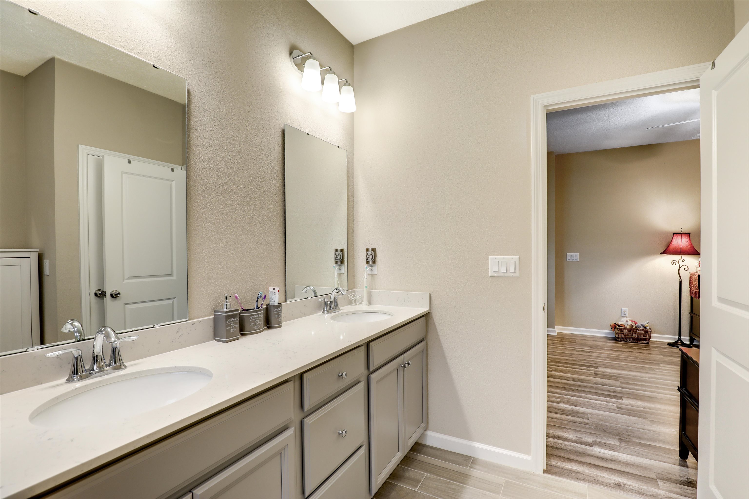 384 Gan Way St. Johns, FL 32259 - Photo 38 of 61 a en suite bathroom with a double vanity sink and a mirror