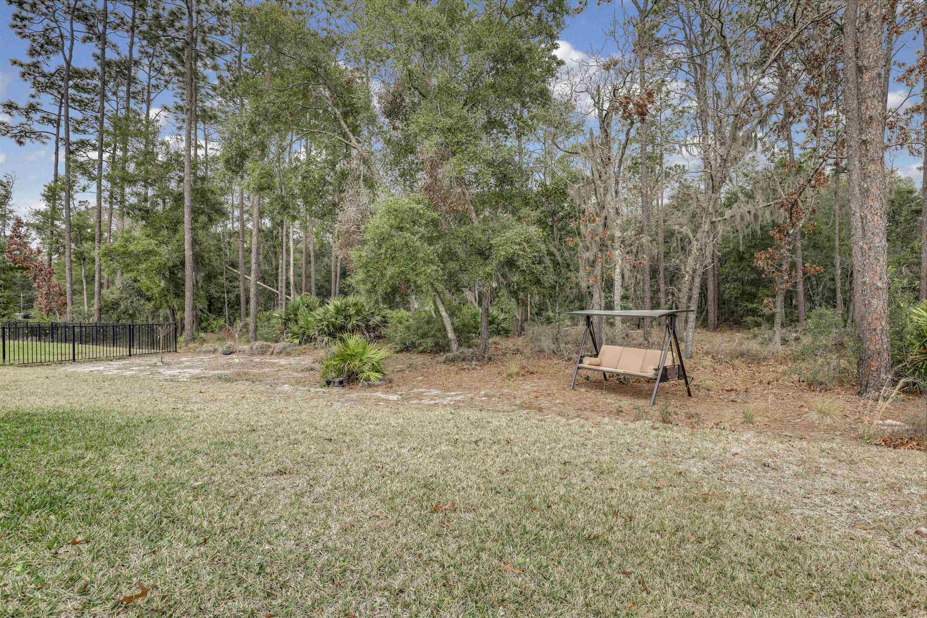 384 Gan Way St. Johns, FL 32259 - Photo 41 of 61 a view of a park with a bench and trees