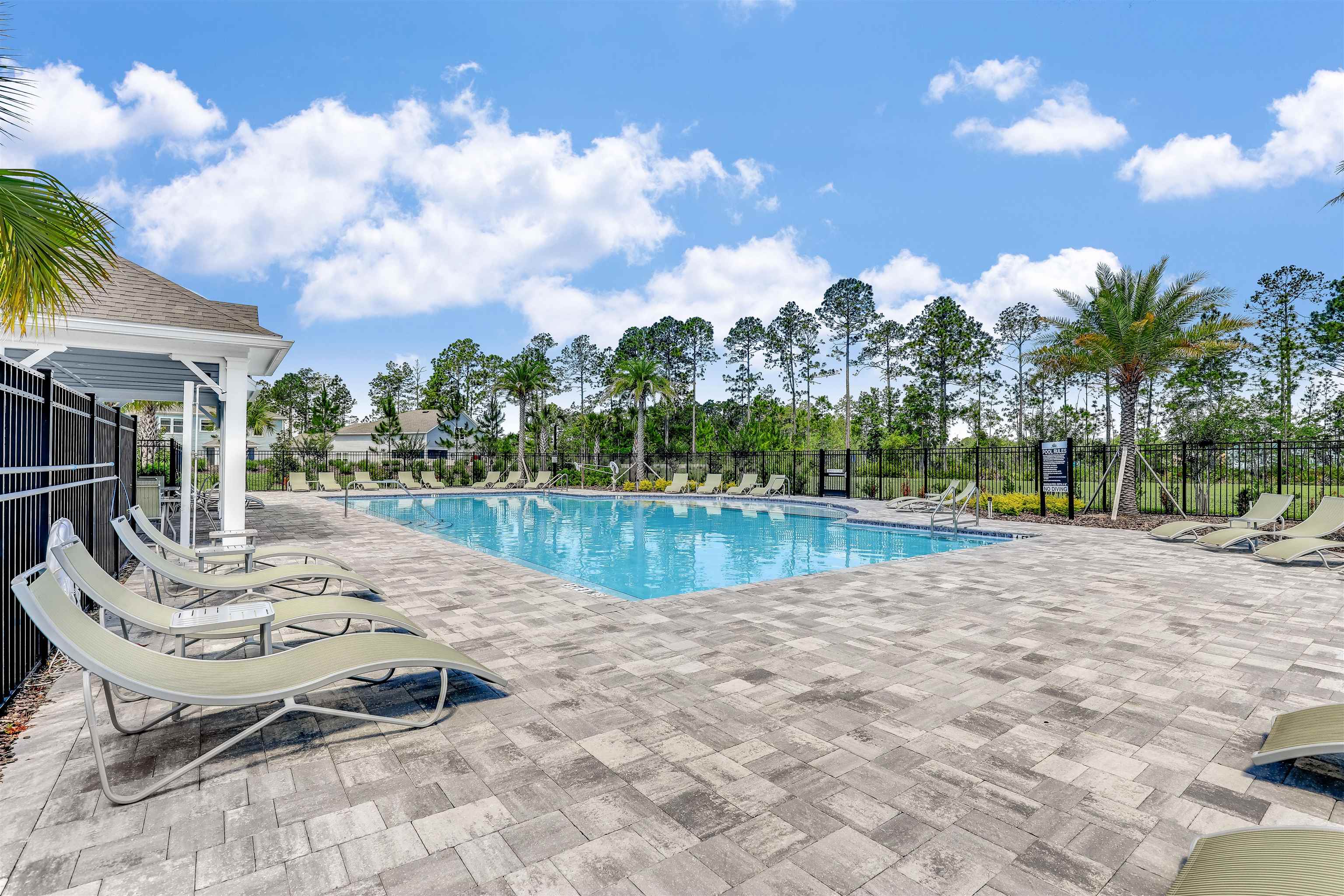 384 Gan Way St. Johns, FL 32259 - Photo 45 of 61 a view of swimming pool with lawn chairs and a yard