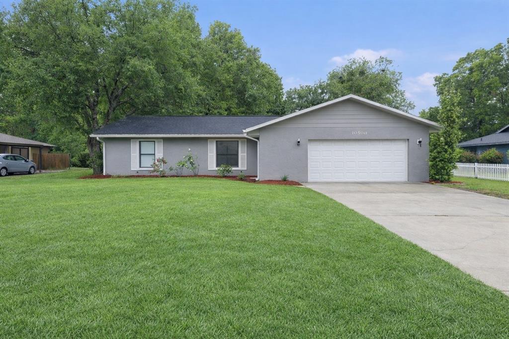 a front view of house with yard and green space