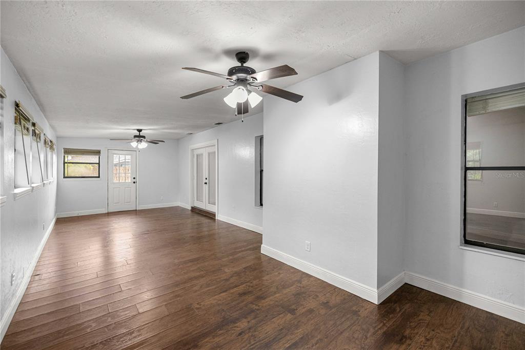 10500 Southwest 74th Court Ocala, FL 34476 - Photo 13 of 28 a view of an empty room with window and wooden floor