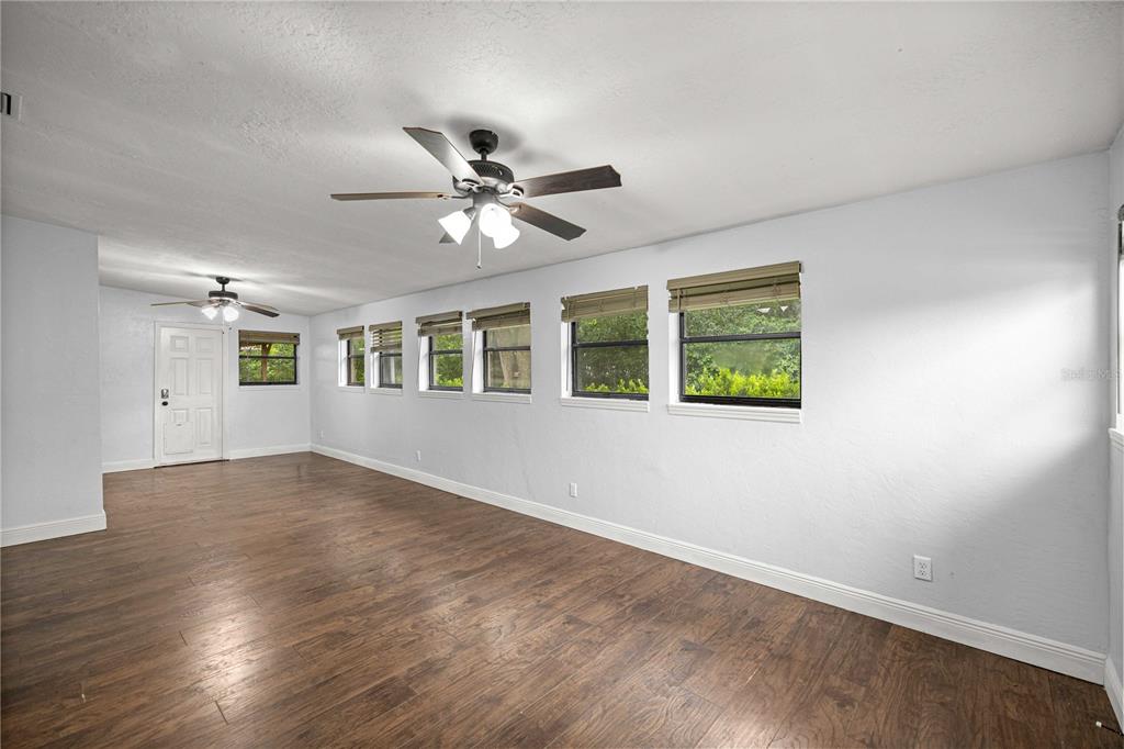 10500 Southwest 74th Court Ocala, FL 34476 - Photo 14 of 28 a view of an empty room with a window and wooden floor