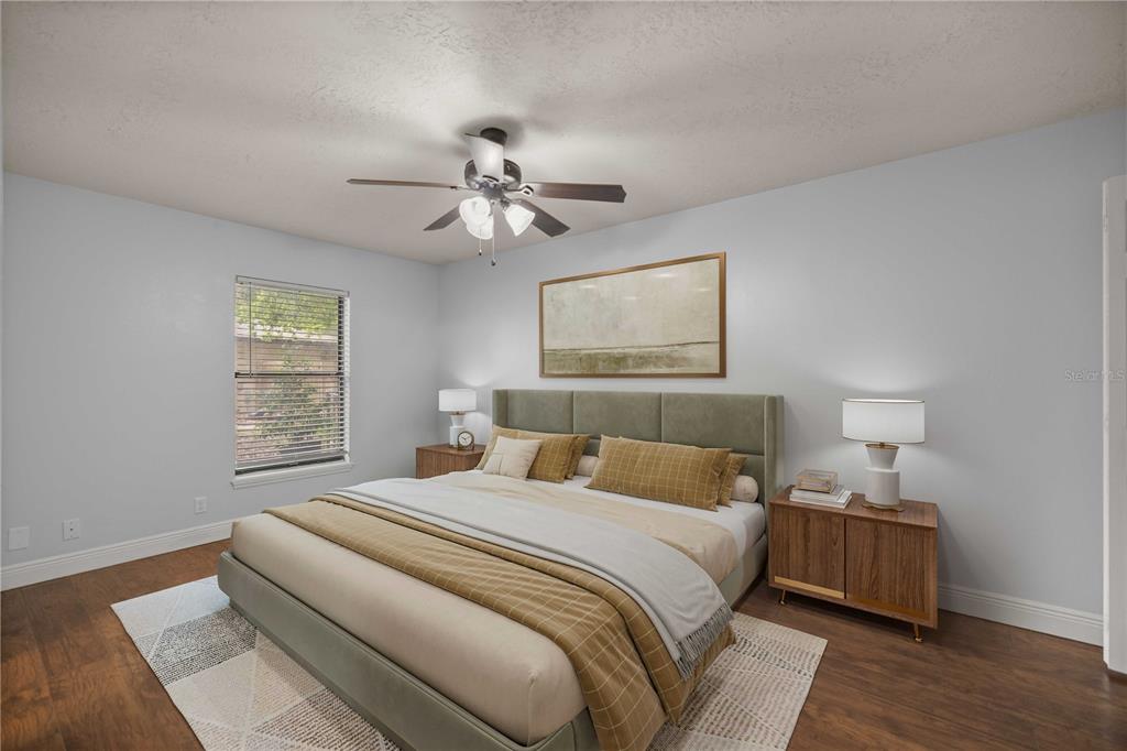 10500 Southwest 74th Court Ocala, FL 34476 - Photo 18 of 28 a bedroom with a bed and a chandelier