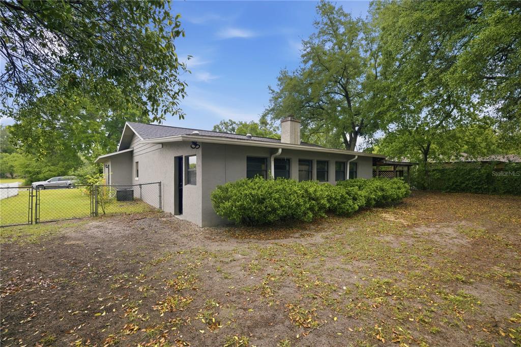 10500 Southwest 74th Court Ocala, FL 34476 - Photo 26 of 28 a view of a house with a backyard and a tree