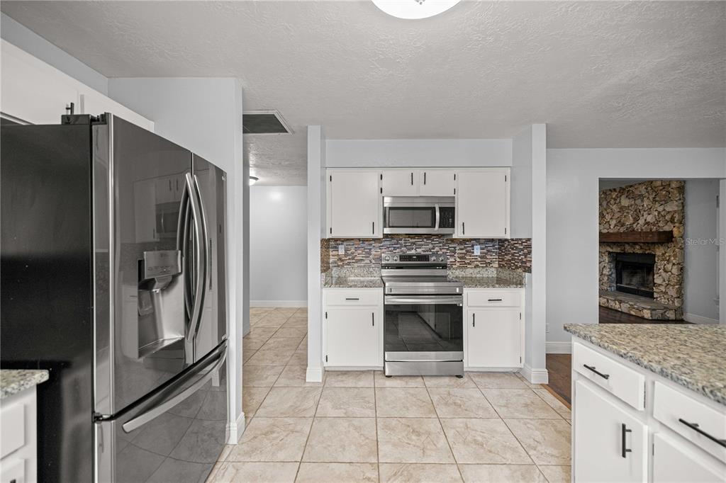 10500 Southwest 74th Court Ocala, FL 34476 - Photo 8 of 28 a kitchen with stainless steel appliances granite countertop a refrigerator and a sink
