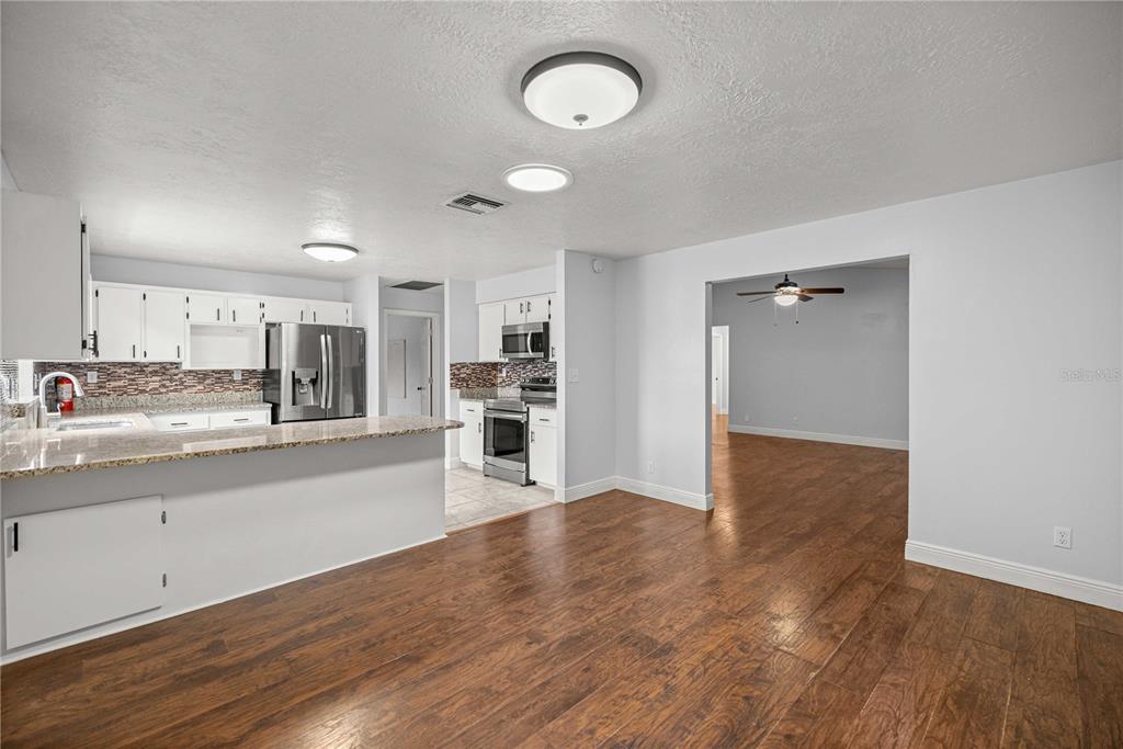 10500 Southwest 74th Court Ocala, FL 34476 - Photo 10 of 28 a large kitchen with wooden floor and stainless steel appliances