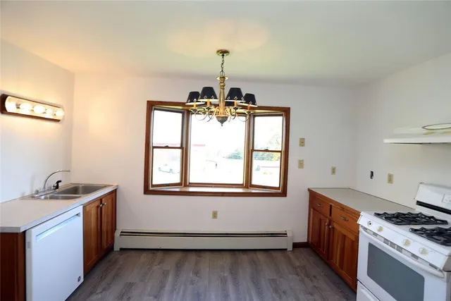 a kitchen with sink stove and cabinets