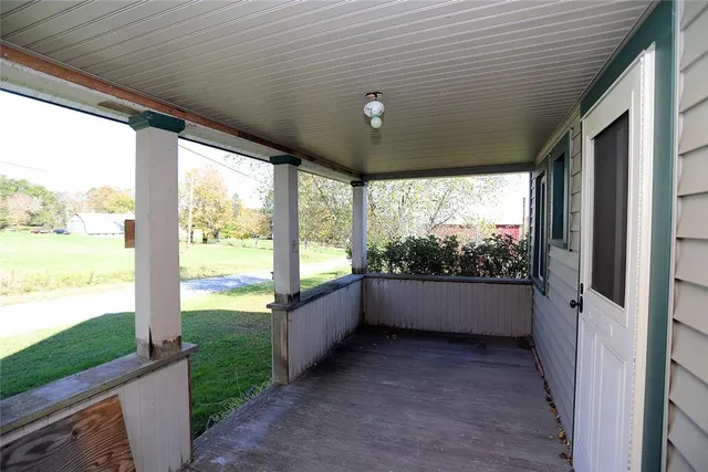 a view of a porch with wooden floor and stairs