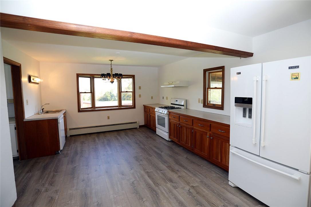 93 Villa Roma Road Callicoon, NY 12723 - Photo 8 of 29 a large kitchen with a wooden floor and stainless steel appliances