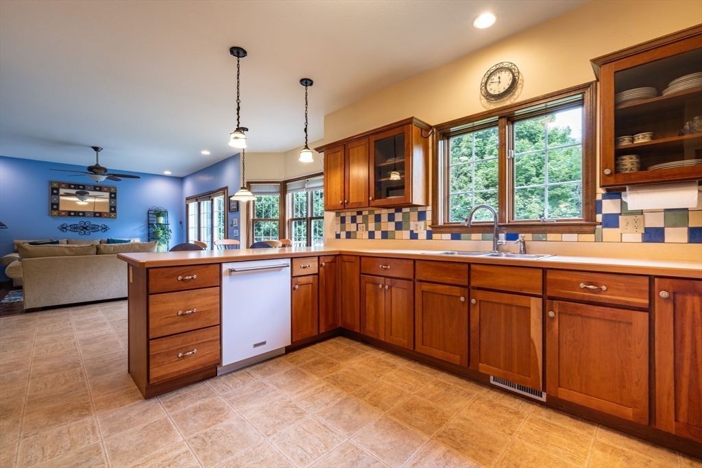 217 Cardinal Way Northampton, MA 01062 - Photo 13 of 37 a kitchen with a sink stove and wooden cabinets