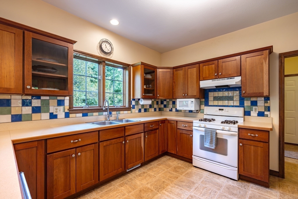 217 Cardinal Way Northampton, MA 01062 - Photo 17 of 37 a kitchen with a sink stove and cabinets