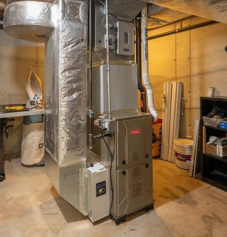 217 Cardinal Way Northampton, MA 01062 - Photo 36 of 37 a room with water heater and wooden cabinets