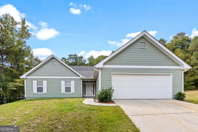 a front view of house with yard and trees