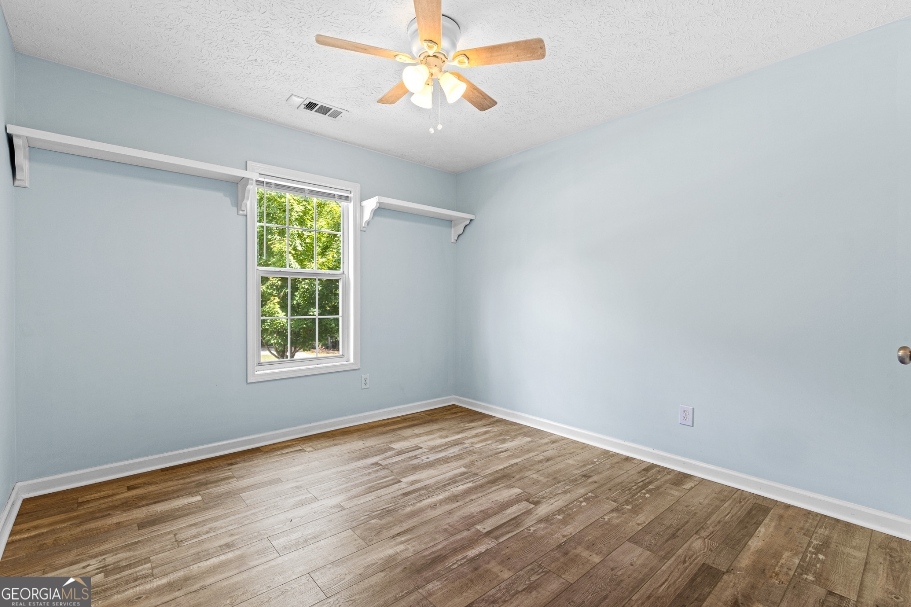 484 Creek Crossing Court Grayson, GA 30017 - Photo 13 of 17 wooden floor in an empty room with a window