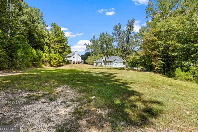 a swimming pool with some trees in the background