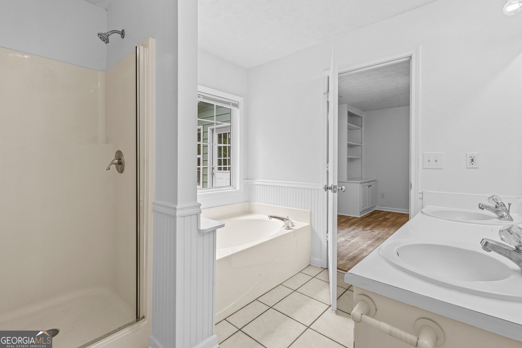 484 Creek Crossing Court Grayson, GA 30017 - Photo 9 of 17 a spacious bathroom with a sink and a mirror