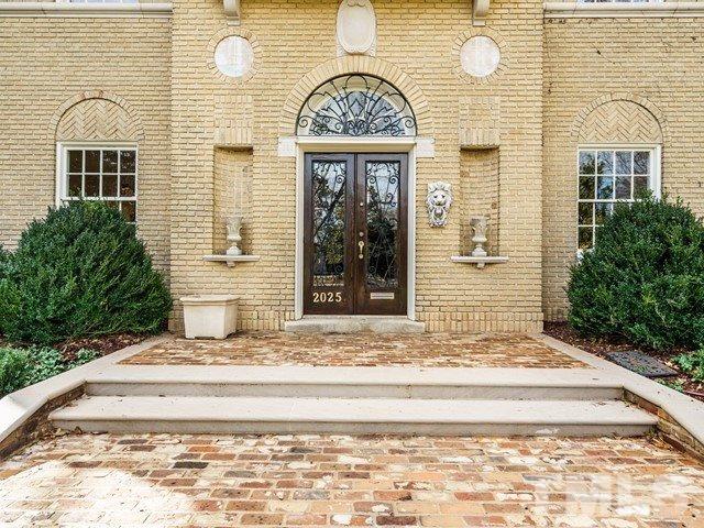 2025 Fairview Road Raleigh, NC 27608 - Photo 2 of 30 a view of a brick house with potted plants
