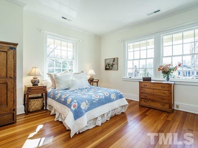 2025 Fairview Road Raleigh, NC 27608 - Photo 20 of 30 a bedroom with a bed and wooden floor