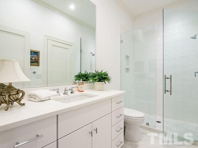 2025 Fairview Road Raleigh, NC 27608 - Photo 21 of 30 a bathroom with a sink a toilet and shower