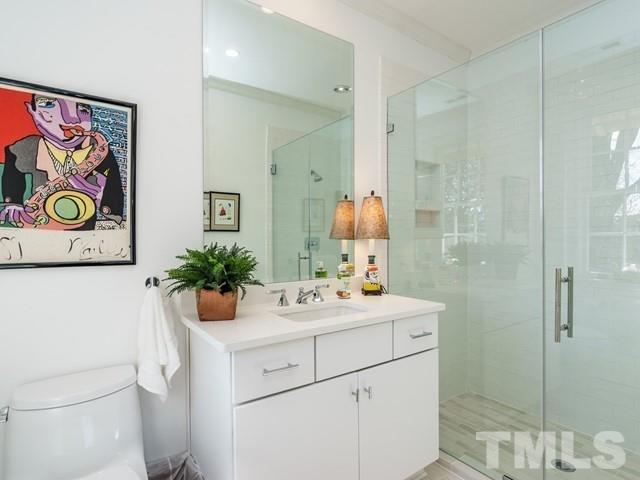 2025 Fairview Road Raleigh, NC 27608 - Photo 23 of 30 a bathroom with a sink a vanity and a shower
