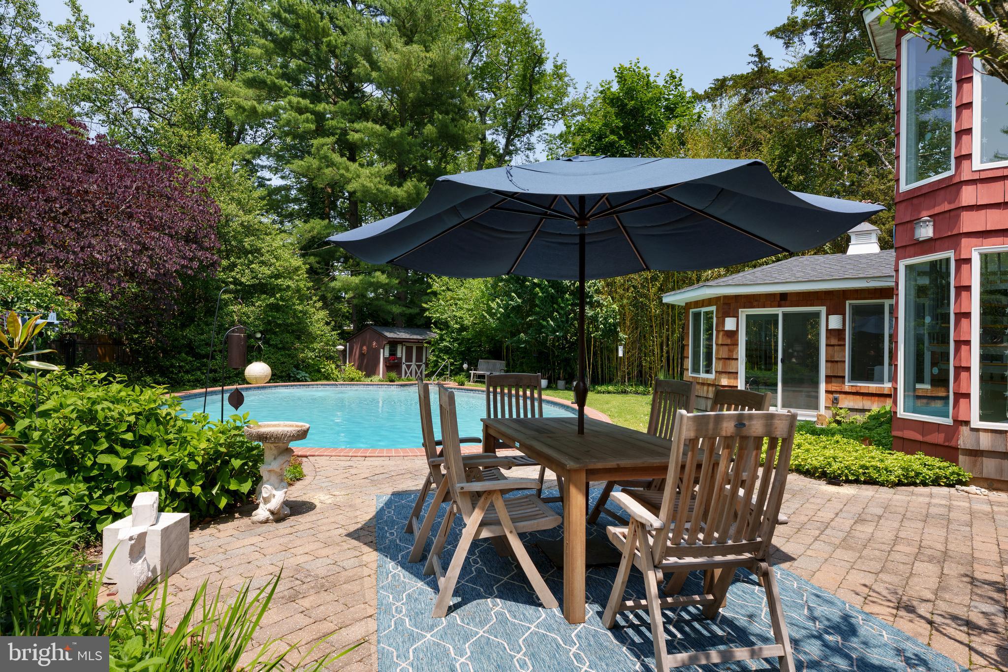 84 Cuyler Road Princeton, NJ 08540 - Photo 24 of 25 a view of a patio with table and chairs under an umbrella