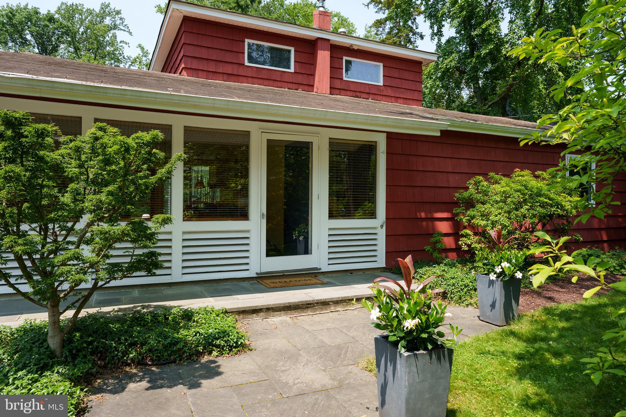 84 Cuyler Road Princeton, NJ 08540 - Photo 3 of 25 a flower garden is sitting in front of a house