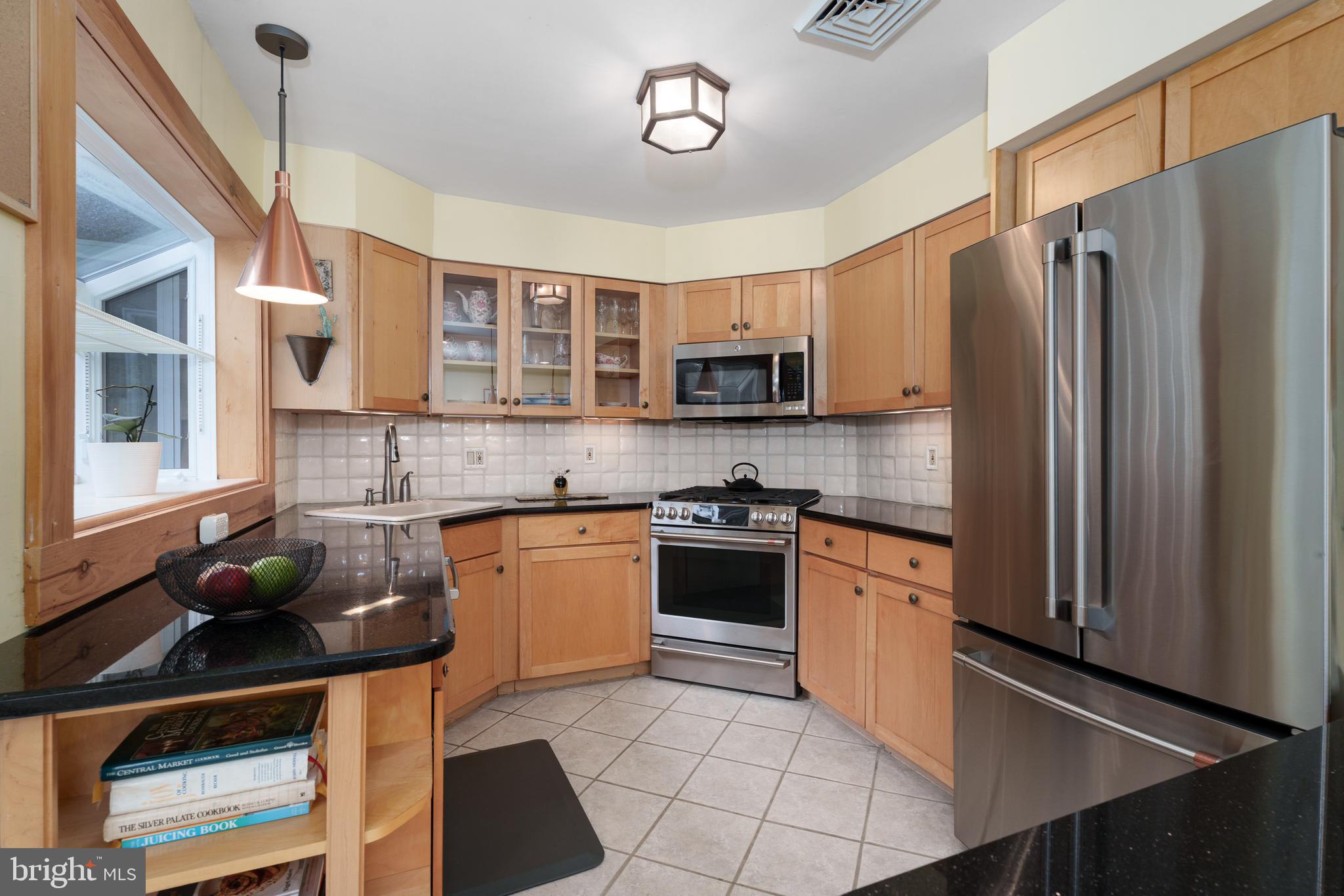 84 Cuyler Road Princeton, NJ 08540 - Photo 8 of 25 a kitchen with stainless steel appliances granite countertop a refrigerator a stove a sink dishwasher and white cabinets with wooden floor