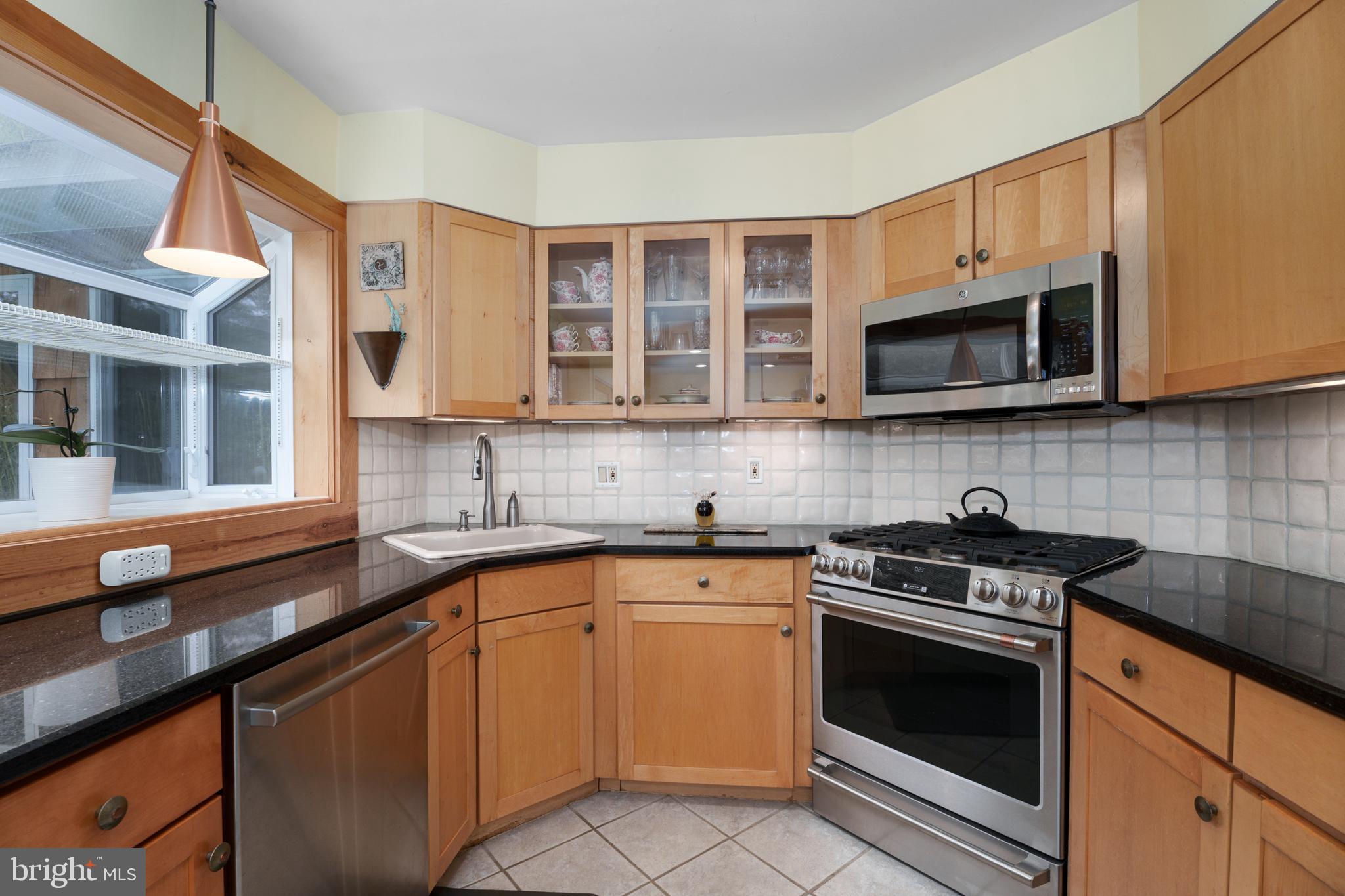 84 Cuyler Road Princeton, NJ 08540 - Photo 9 of 25 a kitchen with stainless steel appliances granite countertop a stove sink microwave and cabinets